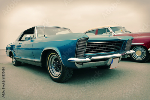 Side view of old luxury car in blue, sixties style, retro