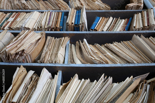 shelves full of files in a messy old-fashioned archive photo