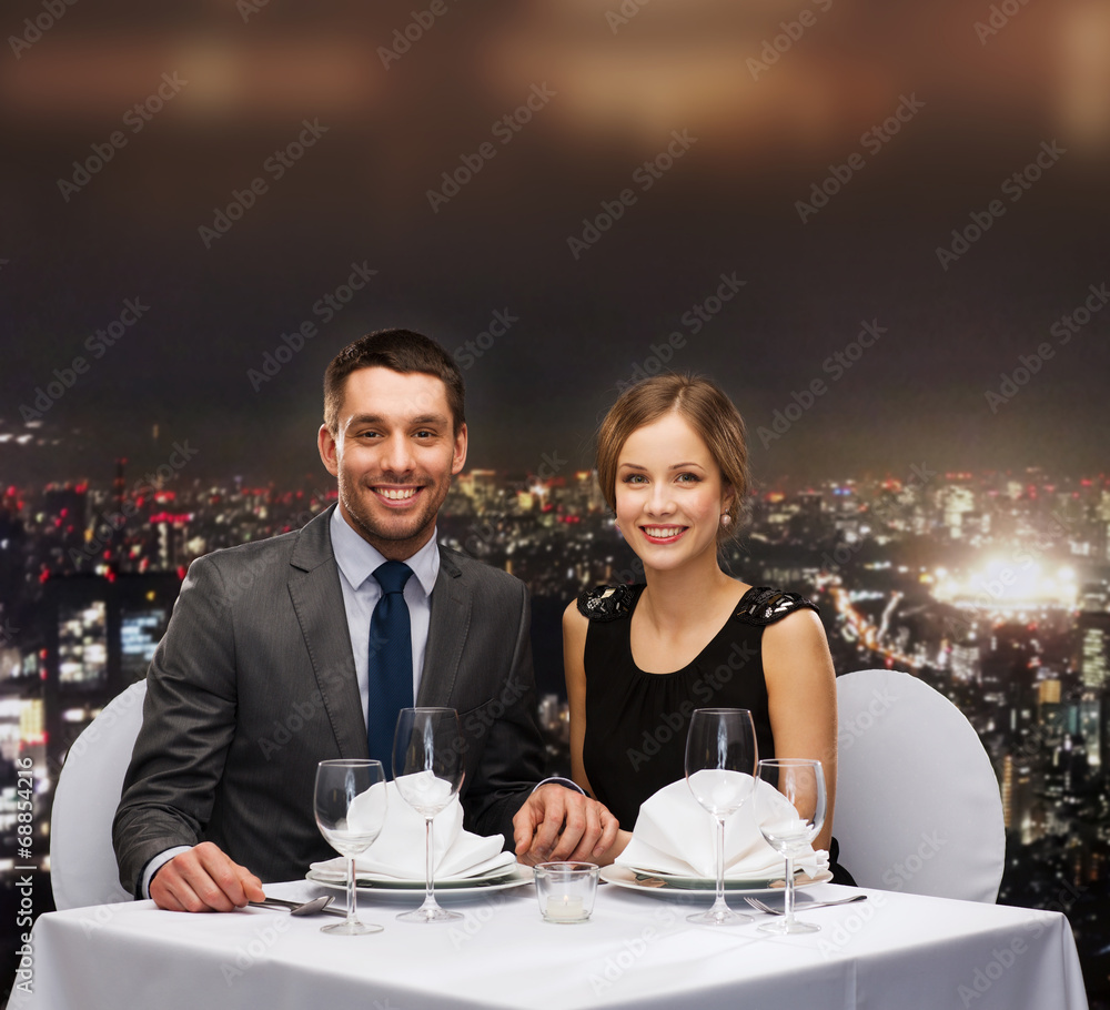 smiling couple holding hands at restaurant smiling couple holding hands at restaurant