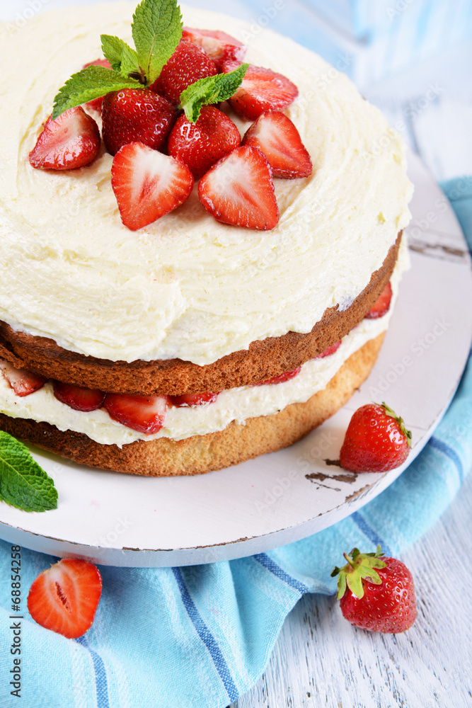 Delicious biscuit cake with strawberries on table close-up Delicious biscuit cake with strawberries on table close-up