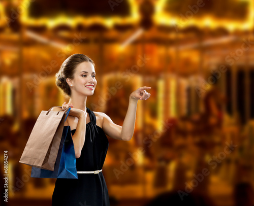smiling woman in dress with shopping bags
