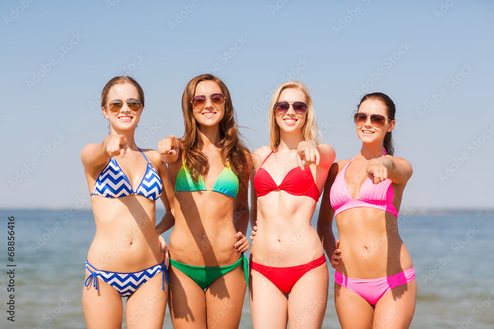 group of smiling young women on beach group of smiling young women on beach