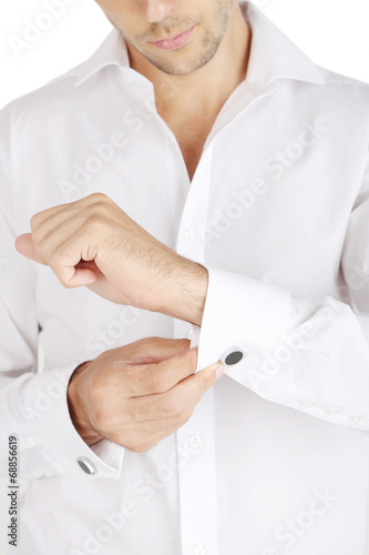 Man in white shirt doing collar button up closeup