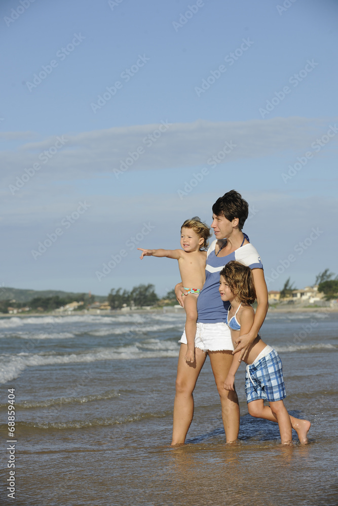 Happy mother and two daughters having fun on the beach. Happy mother and two daughters having fun on the beach.