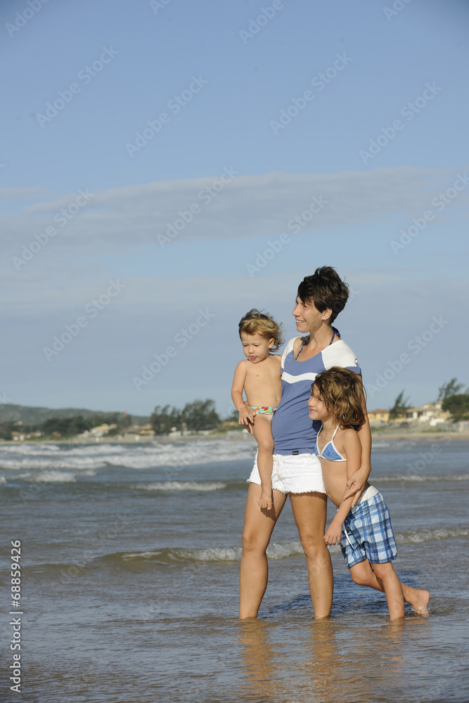 Happy mother and daughters having fun on the beach. Happy mother and daughters having fun on the beach.