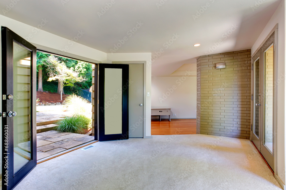 Empty house interior. Living room with door to backyard Empty house interior. Living room with door to backyard