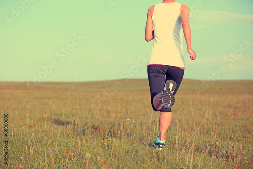 Runner athlete running on grass