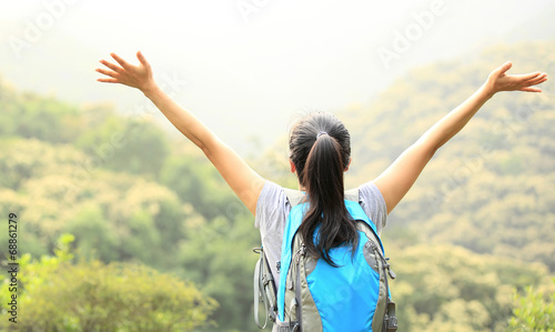 cheering hiking woman open arms mountain peak