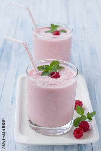 Milkshake with fresh raspberries in a glass