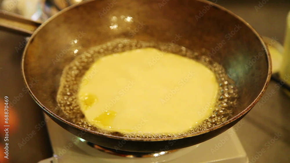 closeup of placing chapati on frying pan closeup of placing chapati on frying pan
