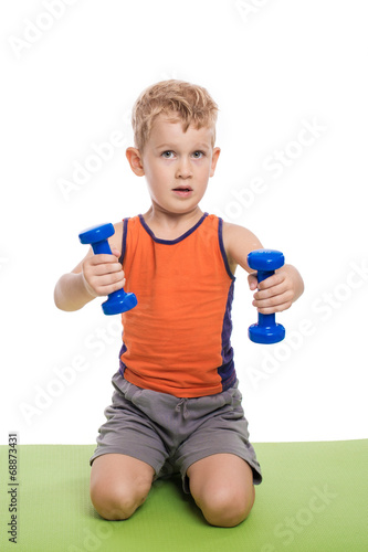 Boy is doing exercises with dumbbells; isolated on the white bac