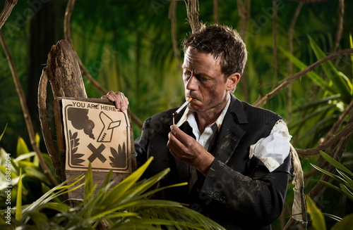 Businessman smoking in the jungle