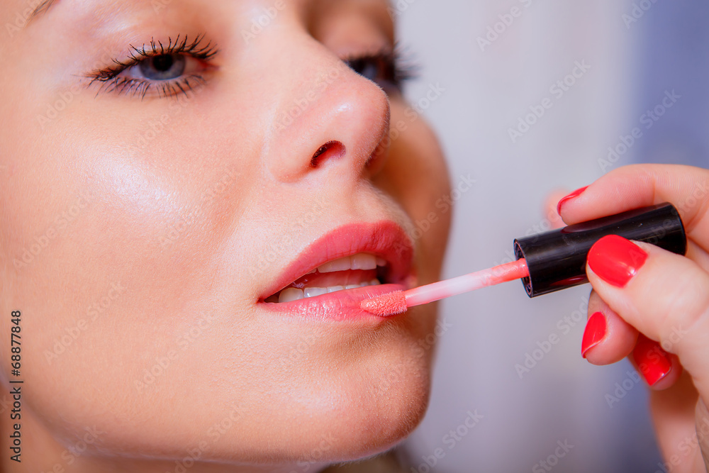 make-up artist doing make-up of a beautiful girl