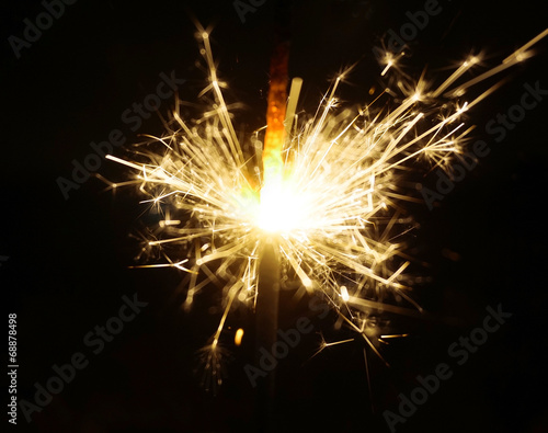 Christmas sparkler on black background. Bengal fire