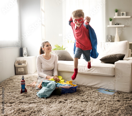 Little superhero helping his mother