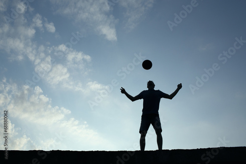 Silhouette of soccer man playing with the ball © danmir12