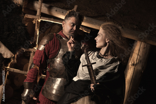 Medieval peasant woman is flirting with the knight