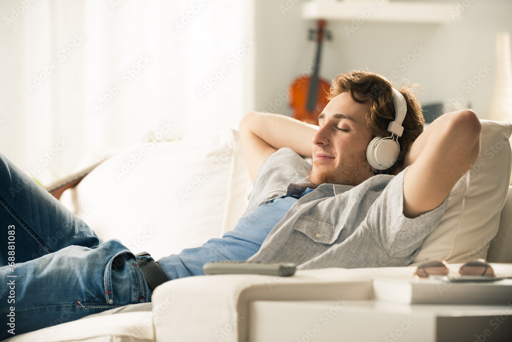 Fototapeta premium Guy with headphones on sofa