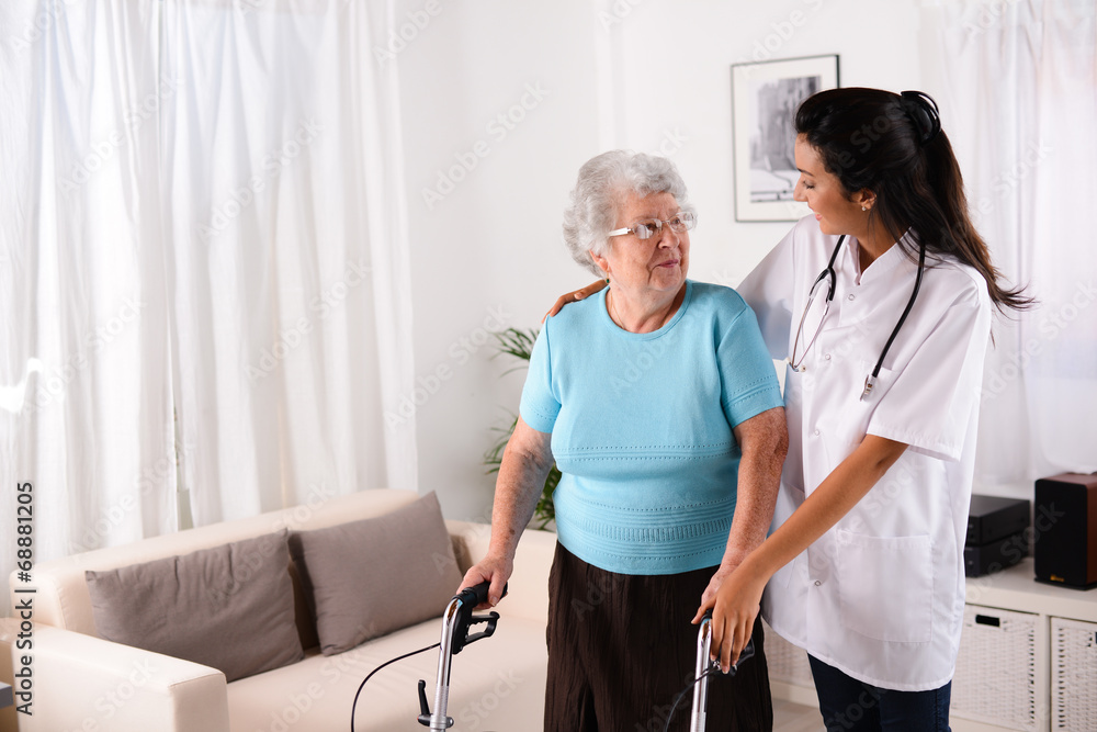 Fototapeta premium cheerful young rehab nurse helping elderly woman using a walker