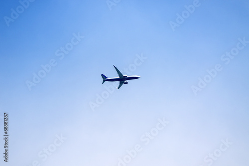 Airplane over clear blue sky