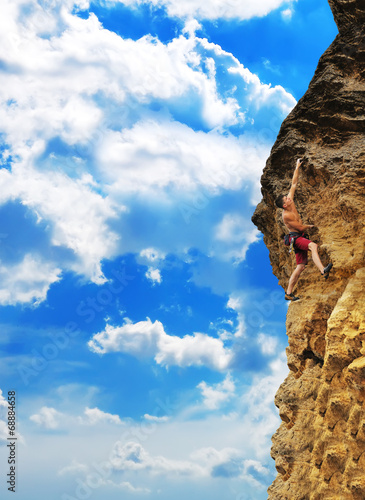 man climbing on rock