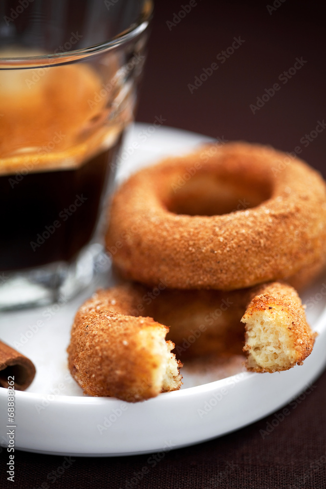 Donuts with cinnamon and coffee, selective focus