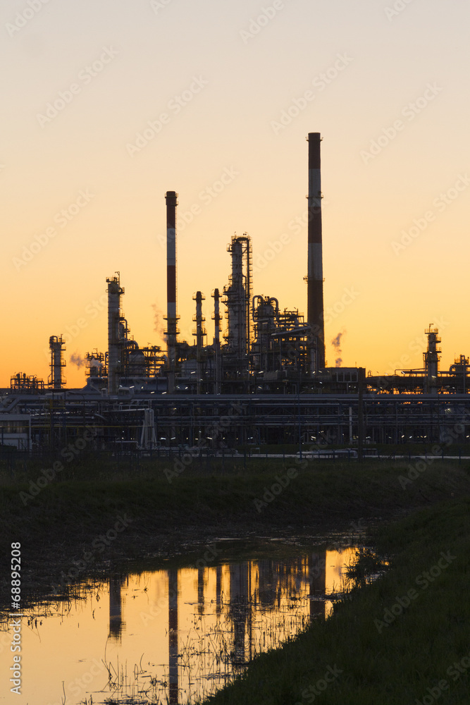 An oil refinery at sunset