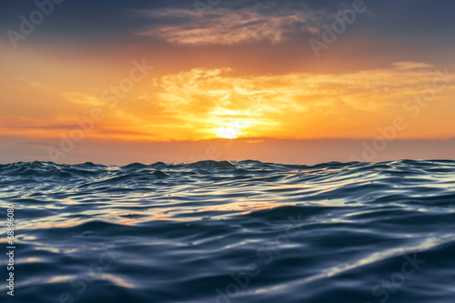 Sunrise and shining waves in ocean