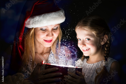 mother and daughter opened a box with a gift