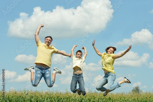 Family jumping on field