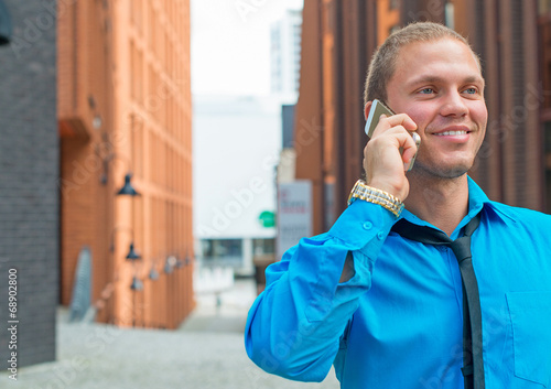 Businessman talking on the mobile phone. Place for text.