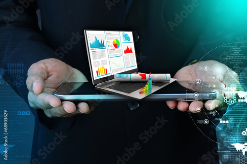 Business man showing financial report in laptop