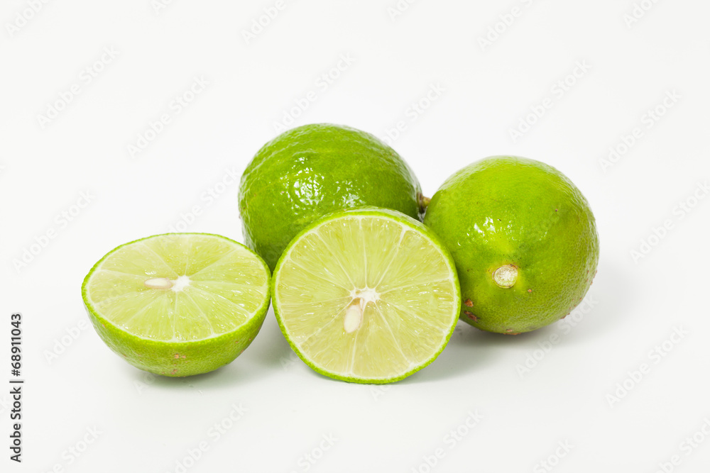 Limes with slices isolated on white background