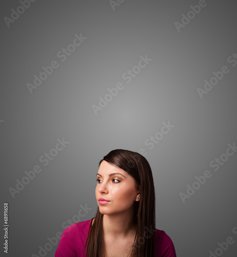 Thoughtful young woman gesturing with copy space