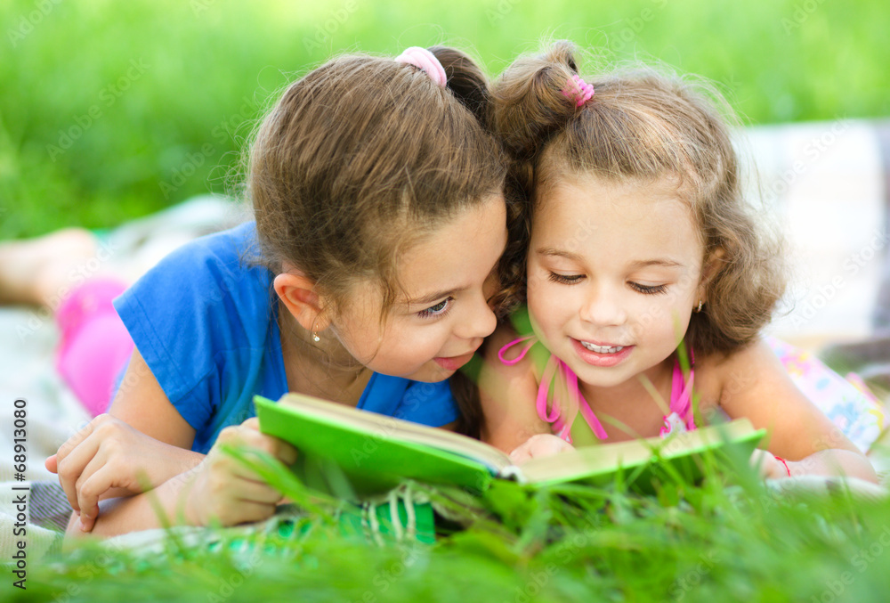 Two little girls are reading book Two little girls are reading book