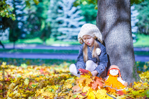 Cute little girl at warm sunny autumn day outdoor