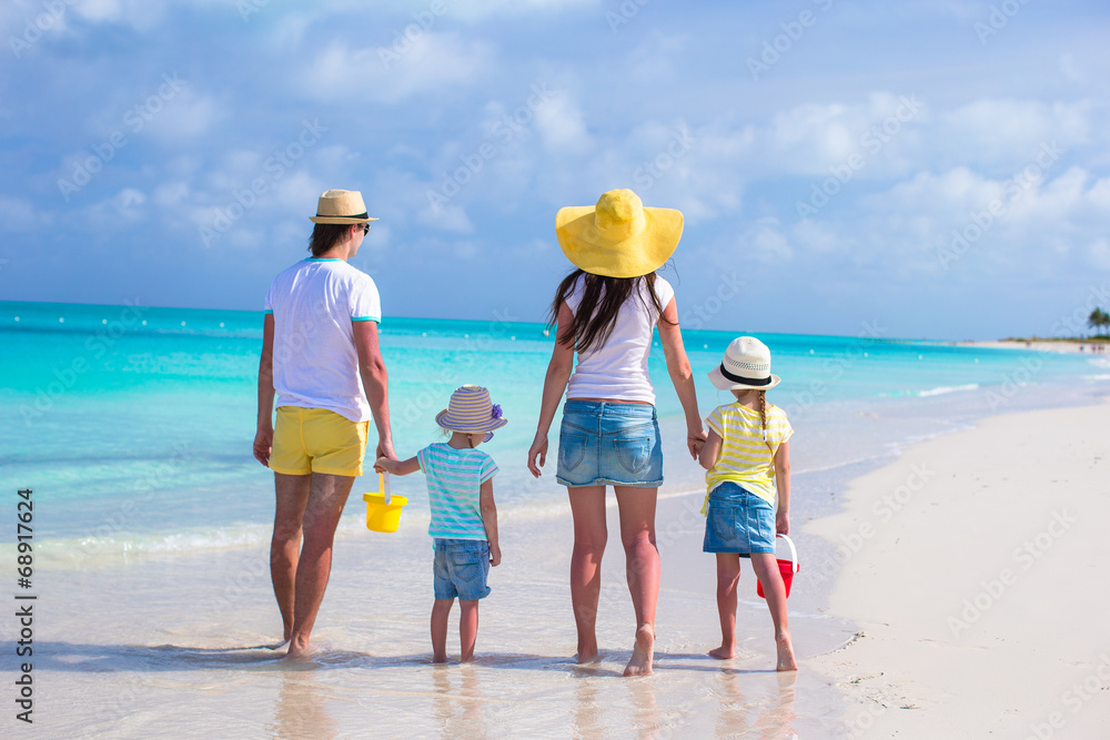 Happy family of four on caribbean holiday vacation Happy family of four on caribbean holiday vacation