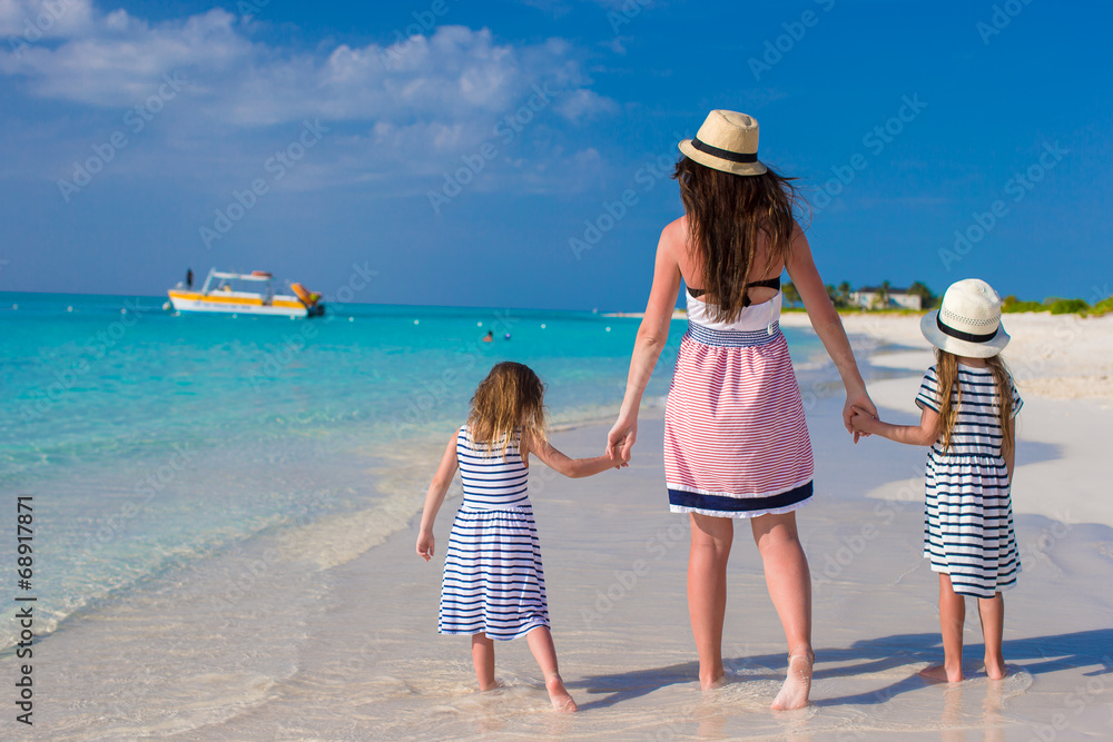 Back view of mother and little daughters enjoy summer vacation