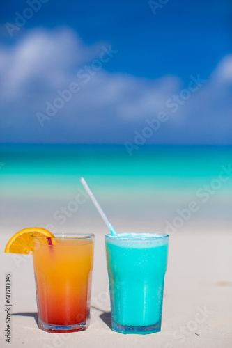 Blue Curacao and Mango cocktail on the white sandy beach