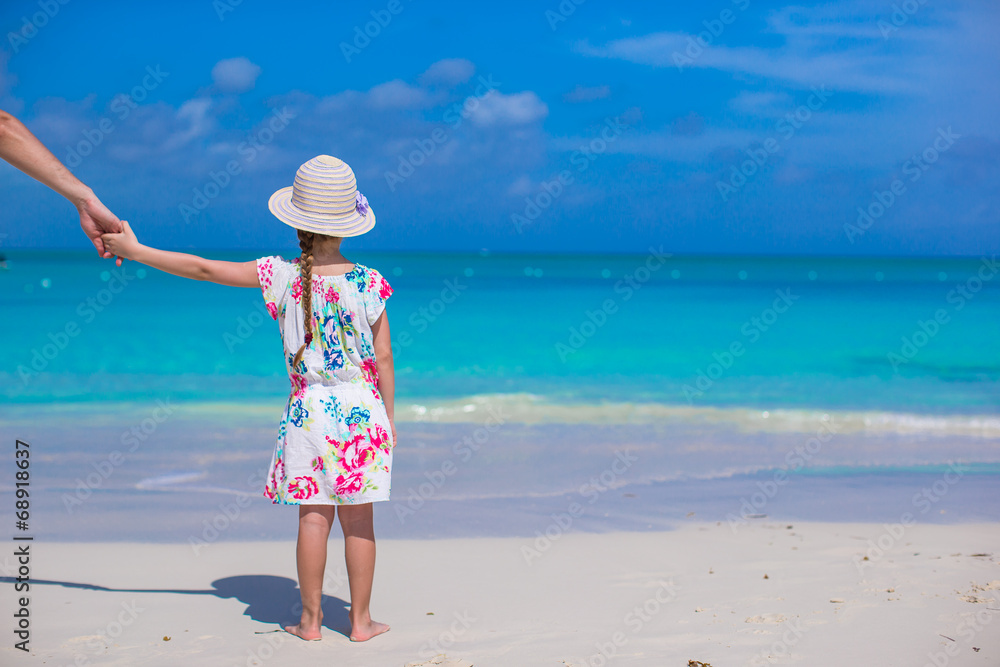 Adorable little girl and father at beach during summer vacation Adorable little girl and father at beach during summer vacation