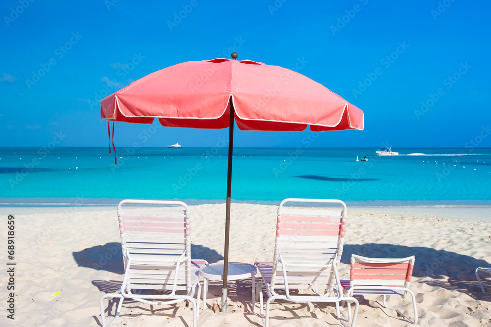 Cute umbrellas and sunbeds at tropical beach