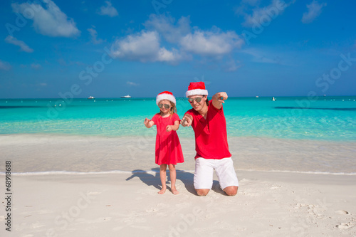 Father and daughter in Santa Hat at tropical beach