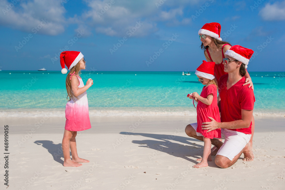 Little girl making photo on phone of her family at the beach Little girl making photo on phone of her family at the beach