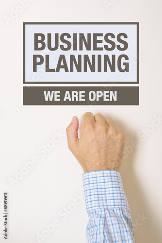 Businessman knocking on Business Planning Office door
