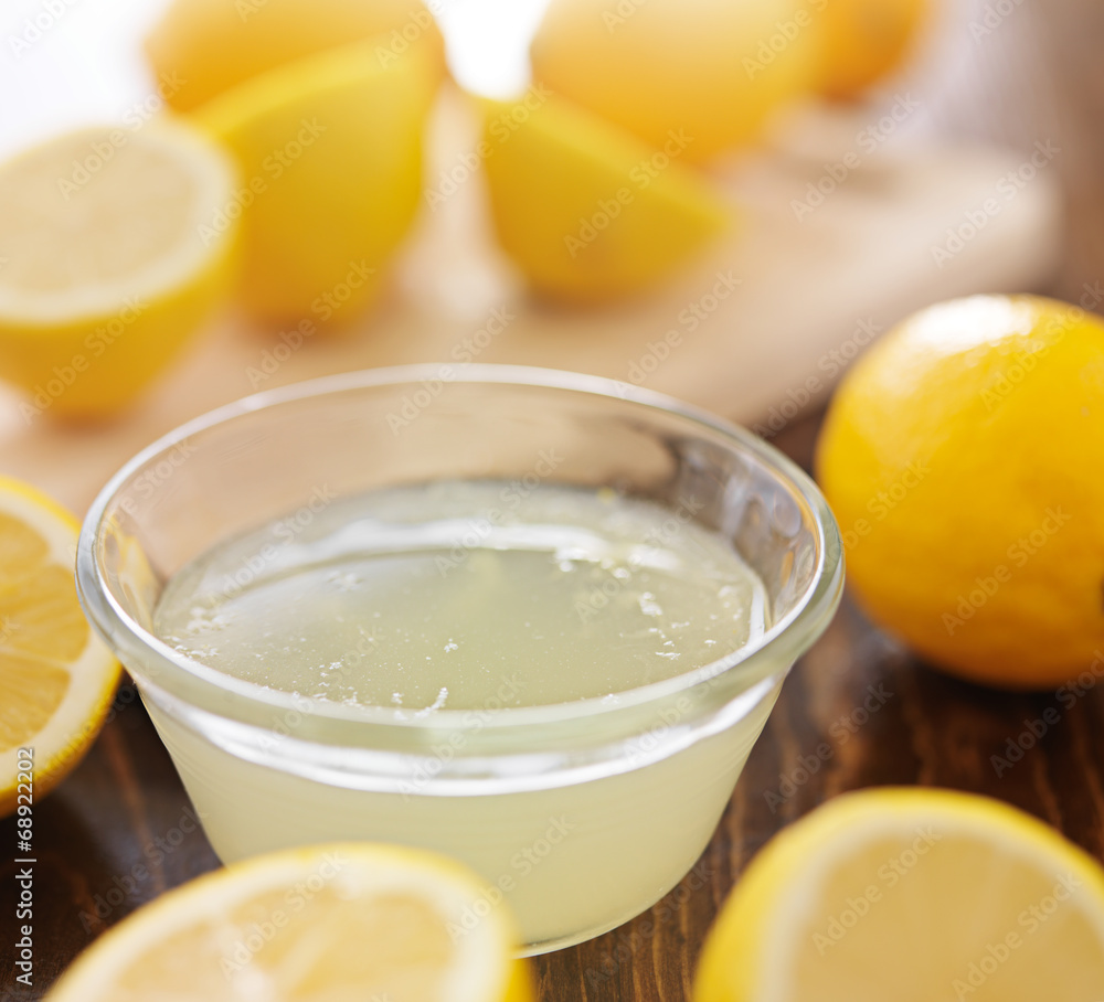 freshly squeezed lemon juice in small bowl freshly squeezed lemon juice in small bowl