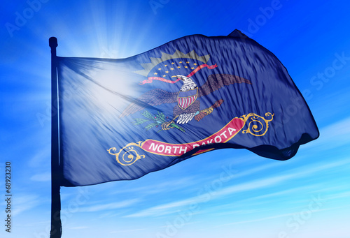 North Dakota (USA) flag waving on the wind photo