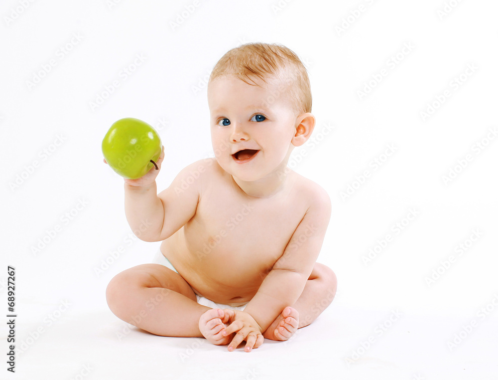 Cute charming smiling baby with green apple Cute charming smiling baby with green apple