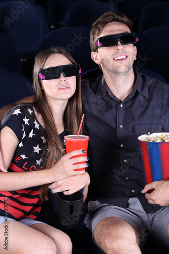 Young couple watching movie...