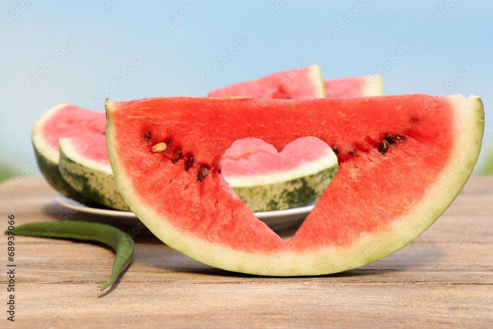 Fresh slice of watermelon on table outdoors, close up Fresh slice of watermelon on table outdoors, close up