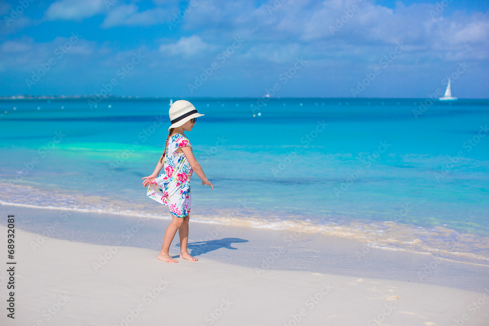 Adorable little girl at white beach during summer vacation Adorable little girl at white beach during summer vacation
